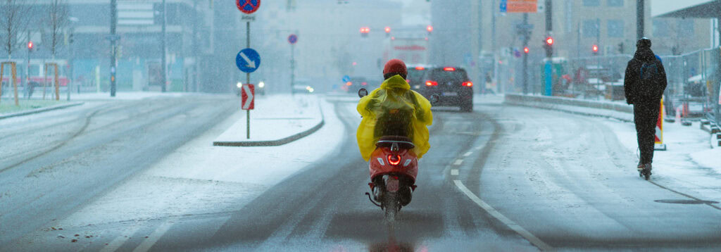 motorcycle rider with pancho in the rain