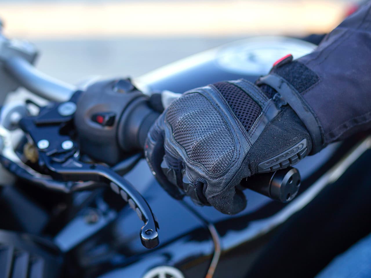 Man with motorcycle and gloved hands